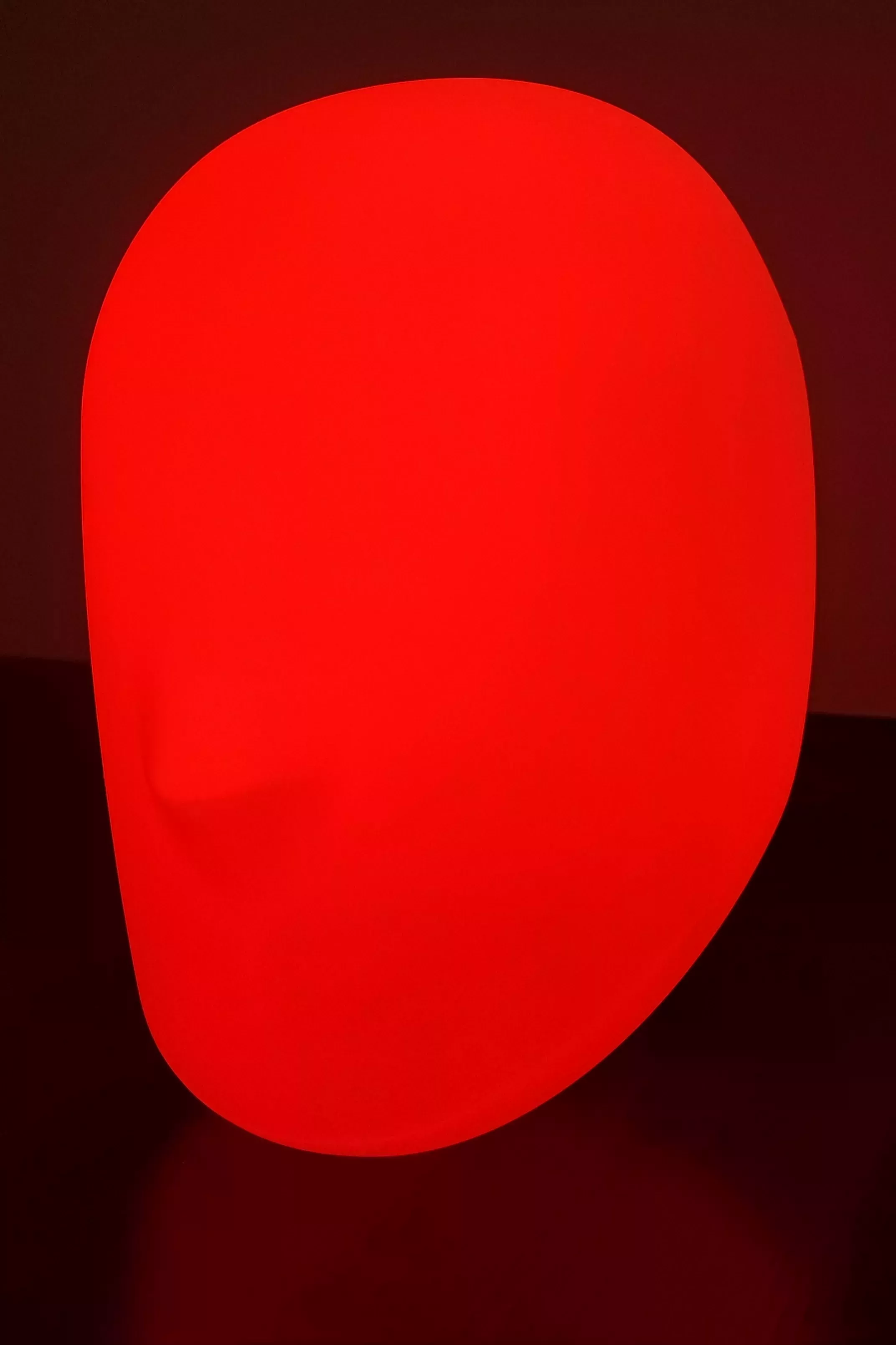 Modified IKEA Iskärna lamp glowing red in a room
